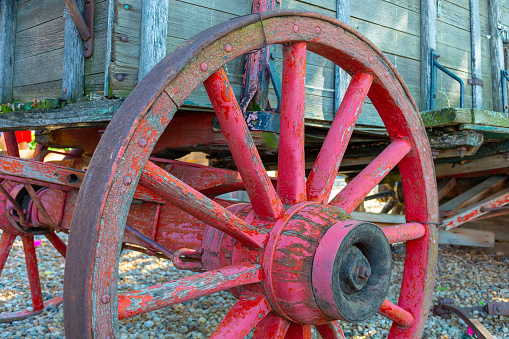 A wagon wheel positioned in an abandoned field