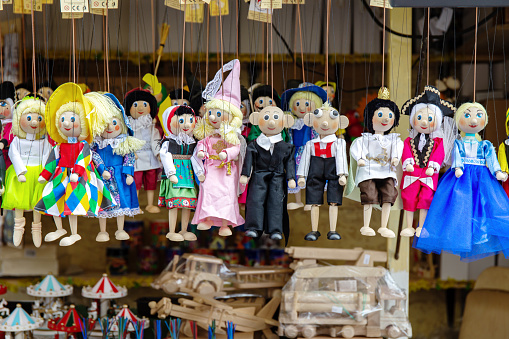 Prague, Czech Republic - March 29, 2018: Wooden dolls of various handmade characters on the counter at the Easter market in Prague, Czech Republic