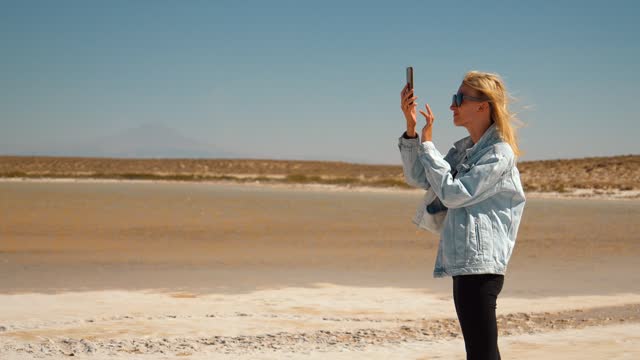 Female Traveler Capturing Salty Lake Tuz in Turkey with Mobile Phone