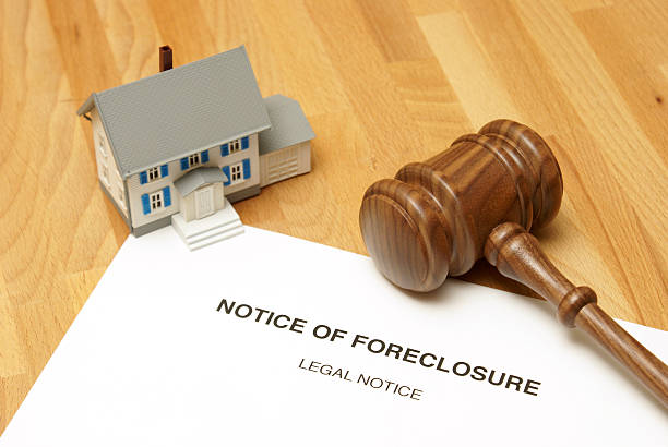 istock Notice of foreclosure document with model house and gavel 183564684