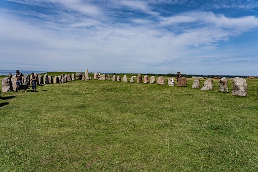 A group of people gathered around the iconic Stonehenge monument, gazing upon the ancient arrangement of standing stones