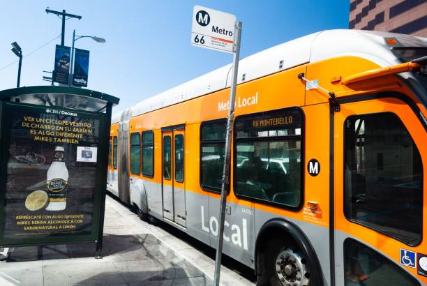Yellow Metro line bus at a bus stop in down town area Los Angeles, United States – June 23, 2013: A yellow Metro line bus at a bus stop in down town area stopover stock pictures, royalty-free photos & images