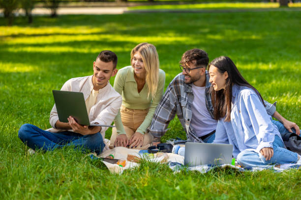 istock Students studying together outdoors on a green lawn 1835670108