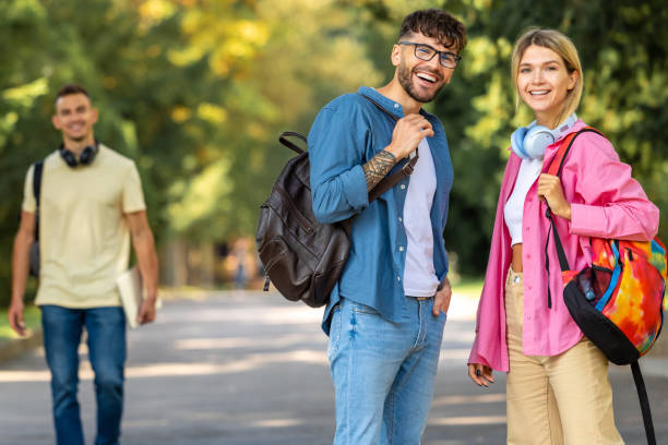 istock Group of young people having a walk in the park 1835671175