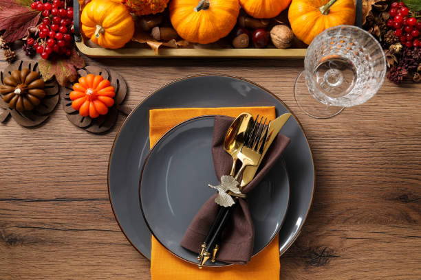 istock Thanksgiving table setting. Plates, cutlery, glass and autumn decor, flat lay 1835690381