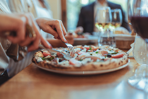 Close Up Image of Woman Eating Pizza at Restaurant