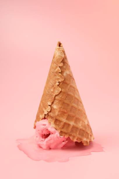 istock Melted ice cream in wafer cone on pink background 1835713441