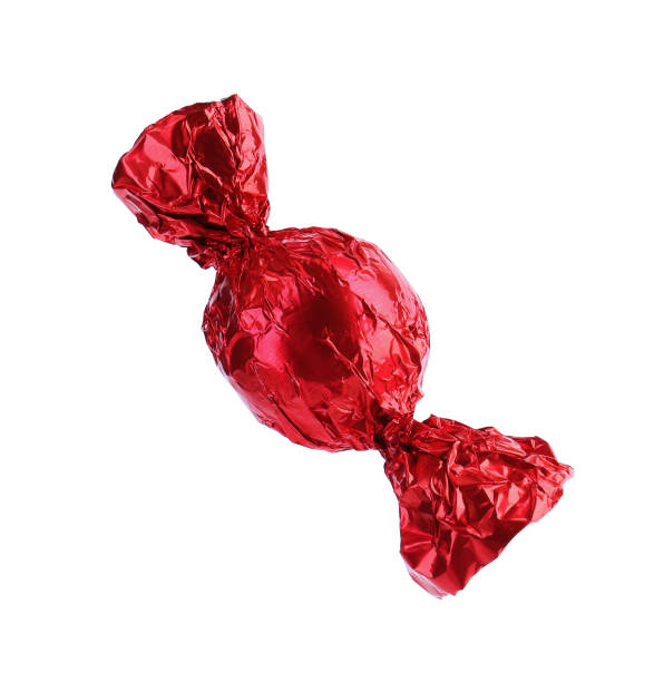 istock Tasty candy in red wrapper isolated on white 1835713981