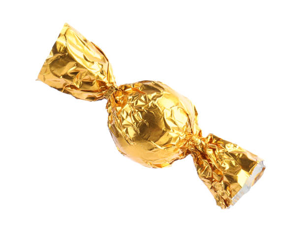 istock Tasty candy in yellow wrapper isolated on white 1835714523