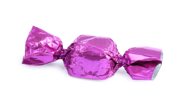 istock Tasty candy in violet wrapper isolated on white 1835714543