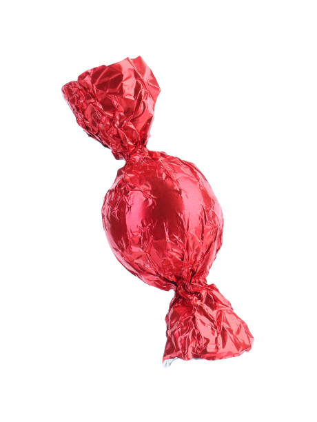 istock Tasty candy in red wrapper isolated on white 1835715118