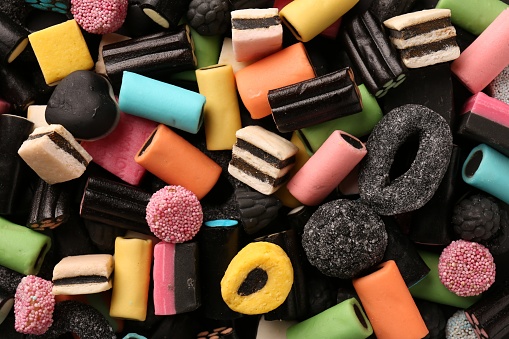 Many different liquorice candies as background, top view
