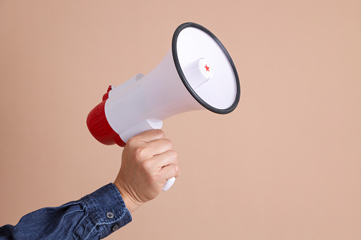 Megaphone isolated on brown background