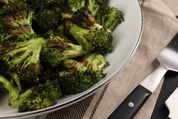 istock Tasty fried broccoli in bowl on table, closeup 1835722219