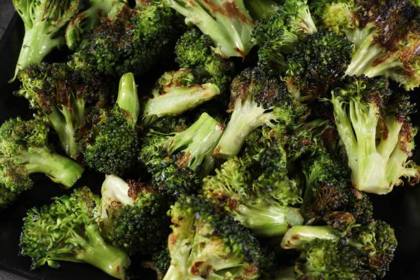 istock Tasty fried broccoli on black plate, top view 1835723935