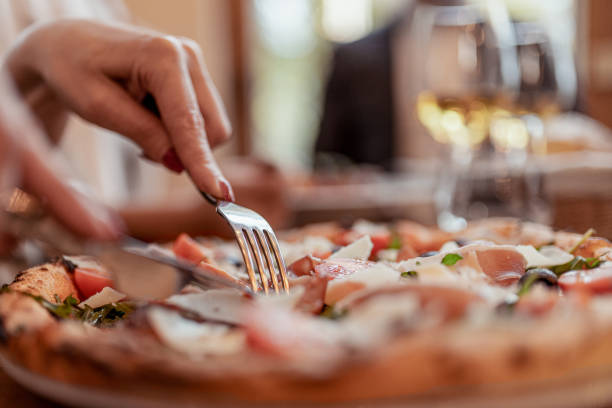 Image of Woman Eating Pizza at Restaurant