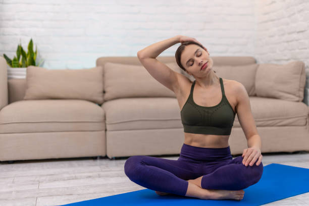 istock Young woman sitting in a lotus pose and doing stretching 1835770162