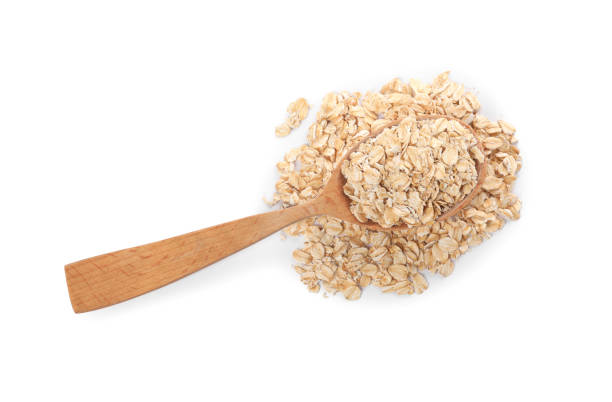 istock Wooden spoon with oatmeal isolated on white, top view 1835772462