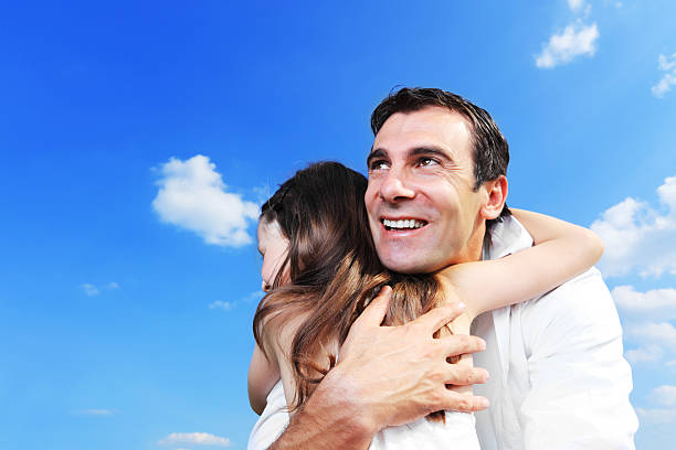 istock Father and daughter are embracing outside. 183578865