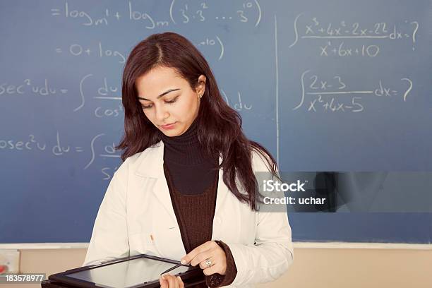 Math Teacher Holding Tablet Pc And Looking It Stock Photo - Download Image Now - 30-39 Years, Adult, Adults Only