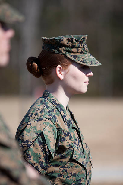 istock A woman Maine in uniform standing at attention 183579048
