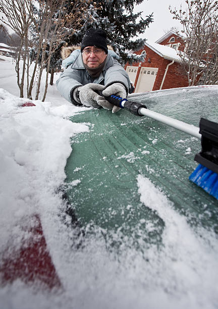 istock Man Cleaning Snow Off Car 183579198