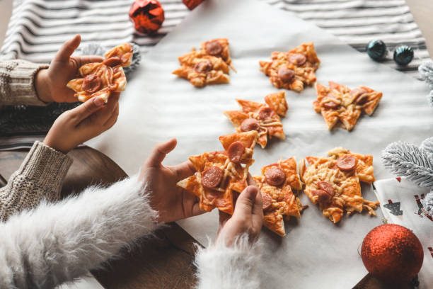 istock Child making pizza in the shape of a Christmas tree, activity idea 1835793046