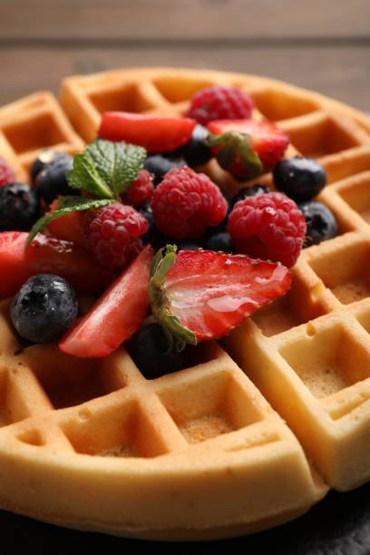 istock Tasty Belgian waffle with fresh berries on table, closeup 1835804842