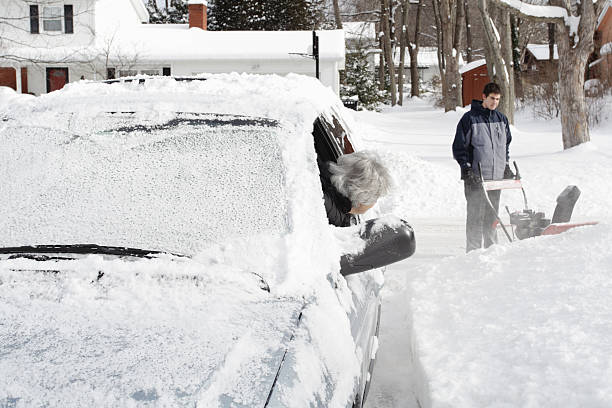 istock Young Man Impatient Waiting on Driveway With Snowblower 183580798