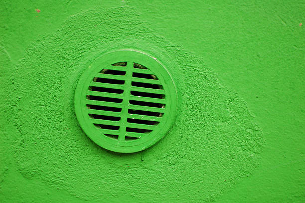 istock Air Duct hole in the green wall. 183581042