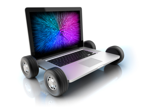 High speed: Laptop on wheels - isolated on white with clipping path