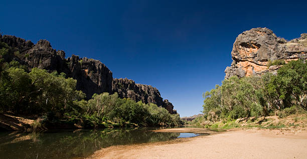 Landscape view of small lake in Windjana Gorge The opening of the famous Windjana Gorge in the remote Kimberley region of Western Australia.  Windjana Gorge is home to one of th most concentrated populations of Freshwater Crocodiles in Australia. kimberley plain stock pictures, royalty-free photos & images