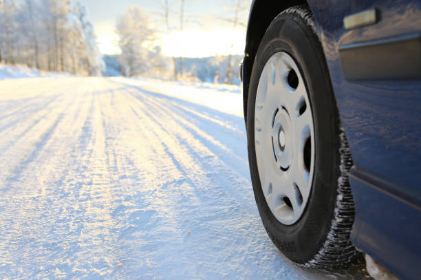 istock Winter tires on snowy road and close-up 1835815921