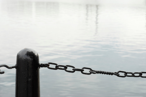 Black chain on river fence