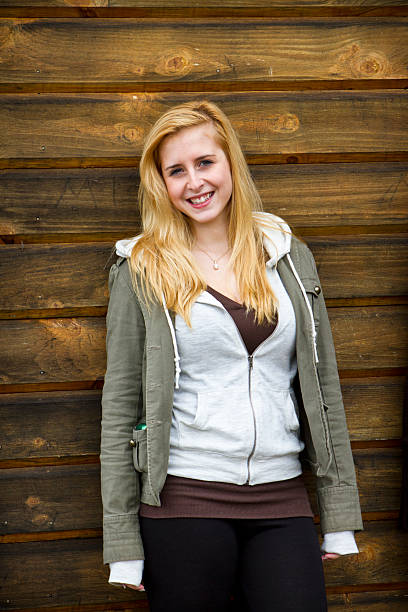 istock young women posed against a wooden background 183582027