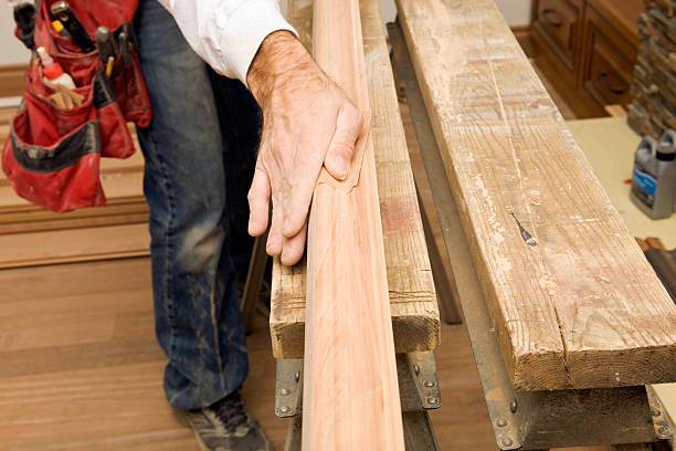 Carpenter Sanding New Cherry Stair Railing  sawhorse stock pictures, royalty-free photos & images