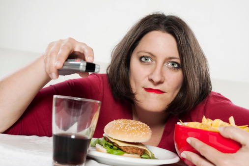 Woman is eating hamburger and chips.More of this model: