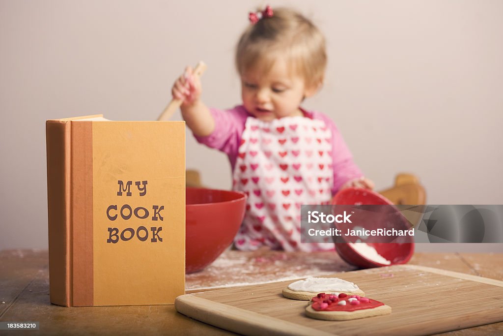 Dziewczynka pieczenia w kuchni - Zbiór zdjęć royalty-free (Książka kucharska)
