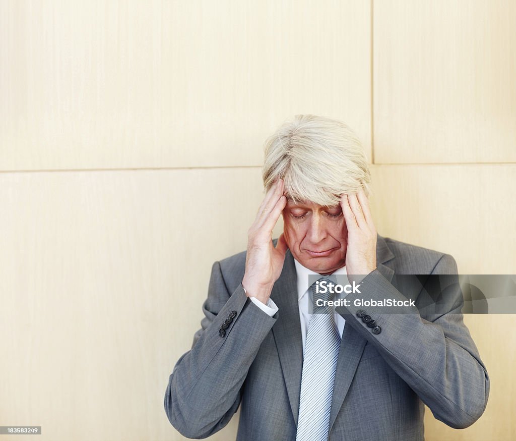 Tensed elderly businessman Closeup portrait of tensed business man with hands on forehead 50-59 Years Stock Photo