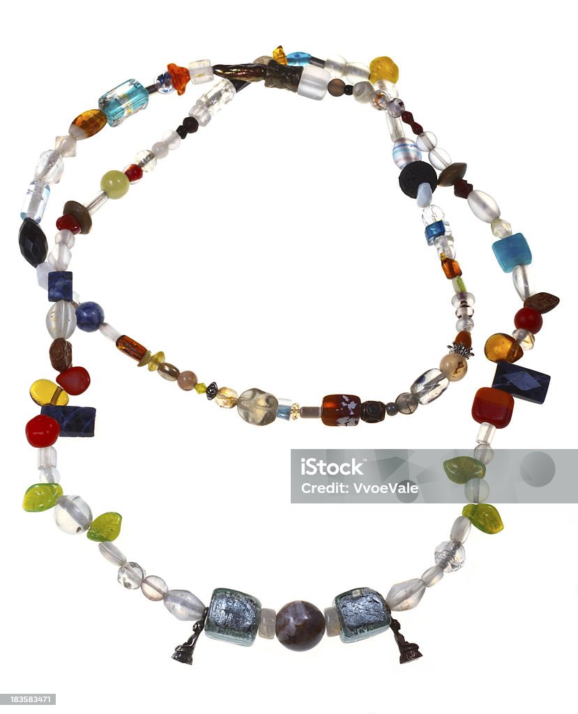 necklace from mineral and figurines of Buddha multi-colored necklace from amethyst, lazurite, onyx, sodalite, glass beads and figurines of Buddha isolated on white background Bead Stock Photo