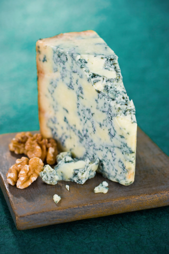 A piquant and beautiful wedge of a rich blue cheese variety known as Stilton.  Shallow dof