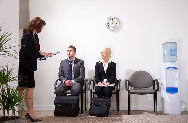 istock two young business people waitning for an interview 183583800