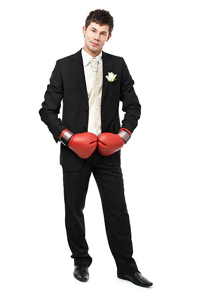 istock young man wearing boxing gloves 183584110