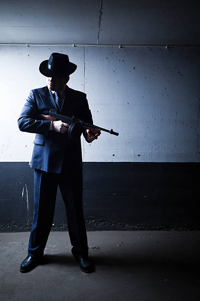 istock Old style gangster with tommy gun in dark setting 183584144