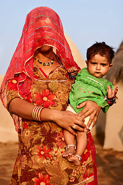 istock Indian woman holding her child 183584159