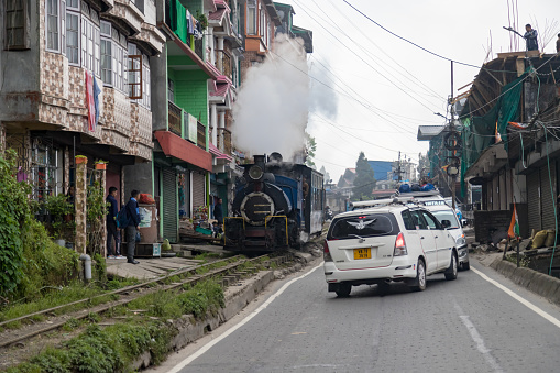 Darjeeling, West Bengal,India,20 April 2022 the toy train of darjeeling is pulled by steam engine which is chugging to ghum station from darjeeling