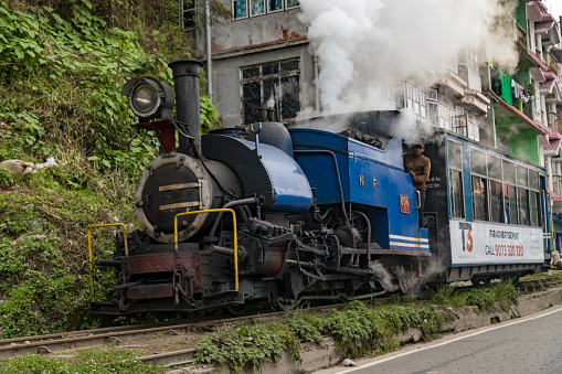 Darjeeling, West Bengal,India,20 April 2022 the toy train of darjeeling is pulled by steam engine which is chugging to ghum station from darjeeling