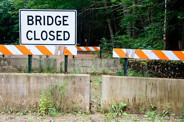 Bridge closed sign with weeds stock photo