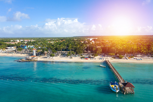 Dominicus beach at Bayahibe with Caribbean sea sandy seashore, lighthouse and pier. Aerial view from drone