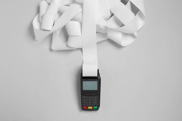 istock Payment terminal with thermal paper for receipt on light grey background, top view 1835867648